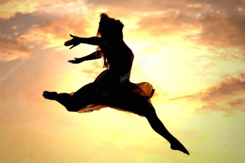 woman jumping in air exhilirated